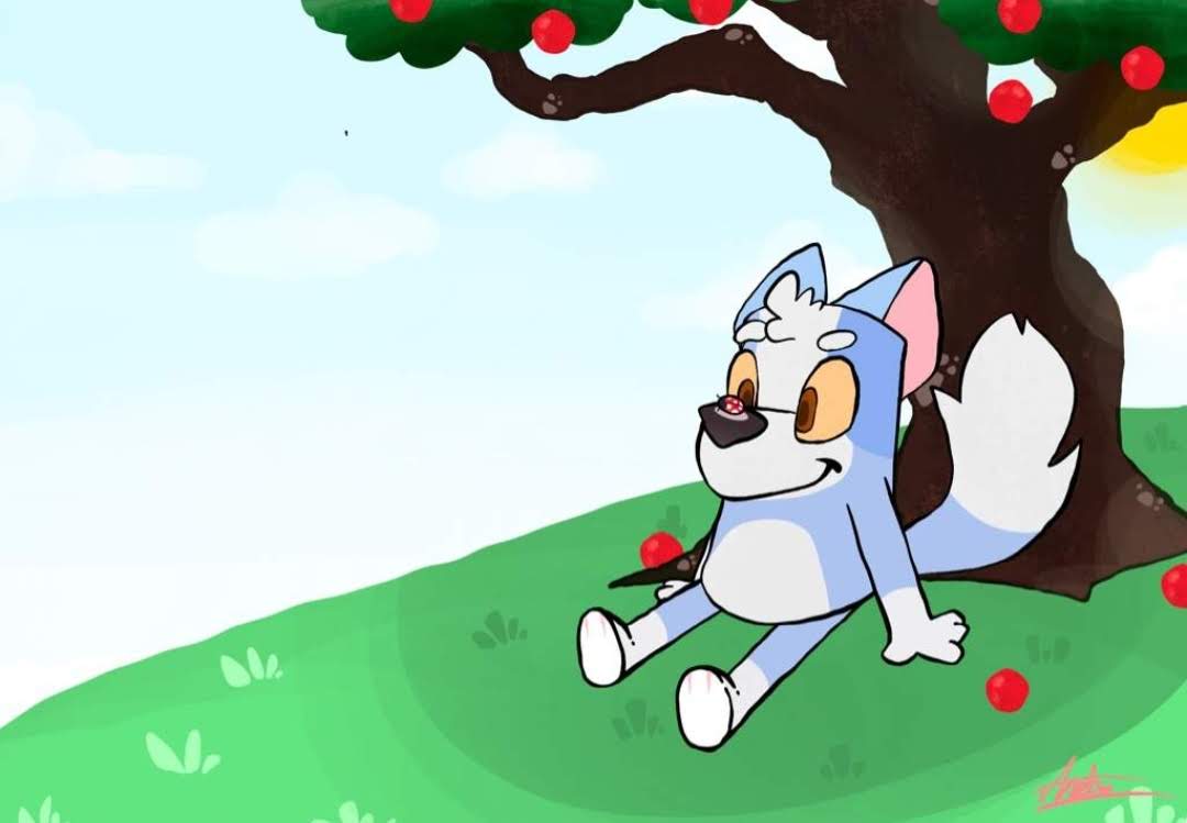 Shifty sitting under a large tree in a green field.